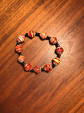 red beaded bracelet made from a cereal box, Haiti Creates